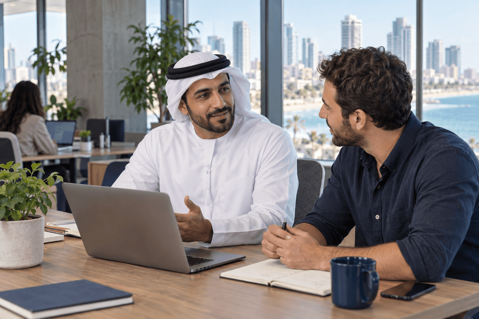 AI illustration of a visitor in Emirati dress working with a colleague in a Tel Aviv-inspired workspace
