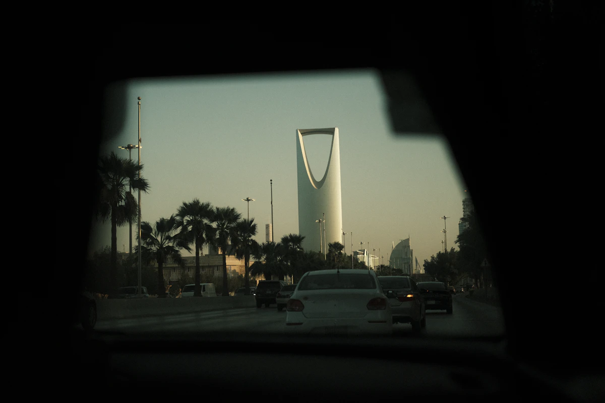 A tower, palm trees and traffic in Riyadh
